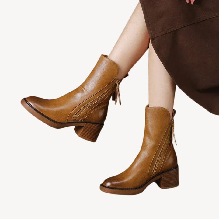 "Women's orthopedic black leather ankle boots with side zipper and moderate heel for comfort and style."