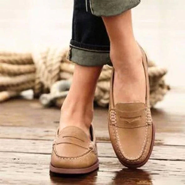 Women's orthopedic leather slip-ons with cushioned insole, sleek design, and soft leather for ultimate comfort and style.
