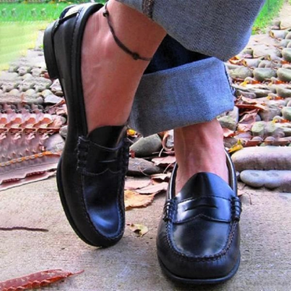 Women's orthopedic leather slip-ons with cushioned insole, sleek design, and soft leather for ultimate comfort and style.