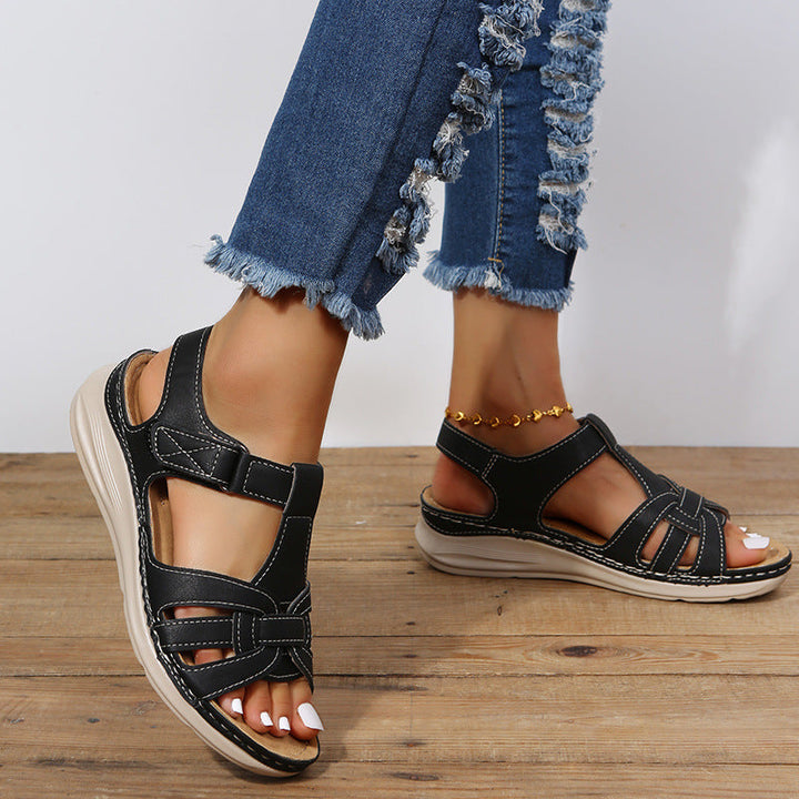 "Women's orthopedic sandals with Velcro straps, faux leather, cushioned footbed, and rubber sole for comfort and style."