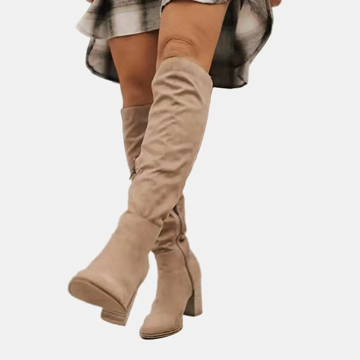Elegant women's over-the-knee block heel boots for autumn/winter. Chic and comfortable tall fashion footwear.