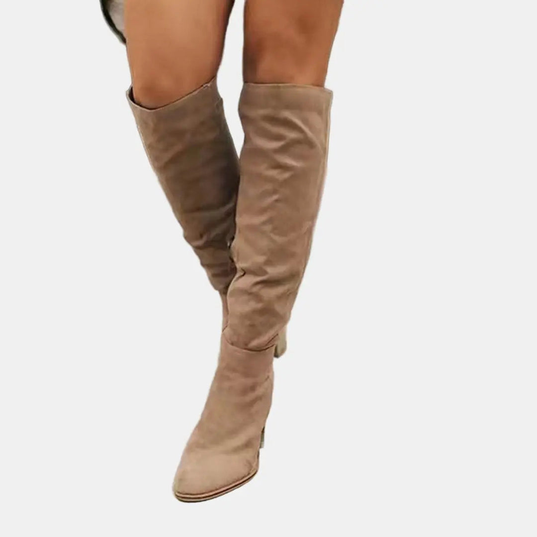Women's elegant over-the-knee block heel boots. Comfortable, chic, and tall for autumn/winter fashion.