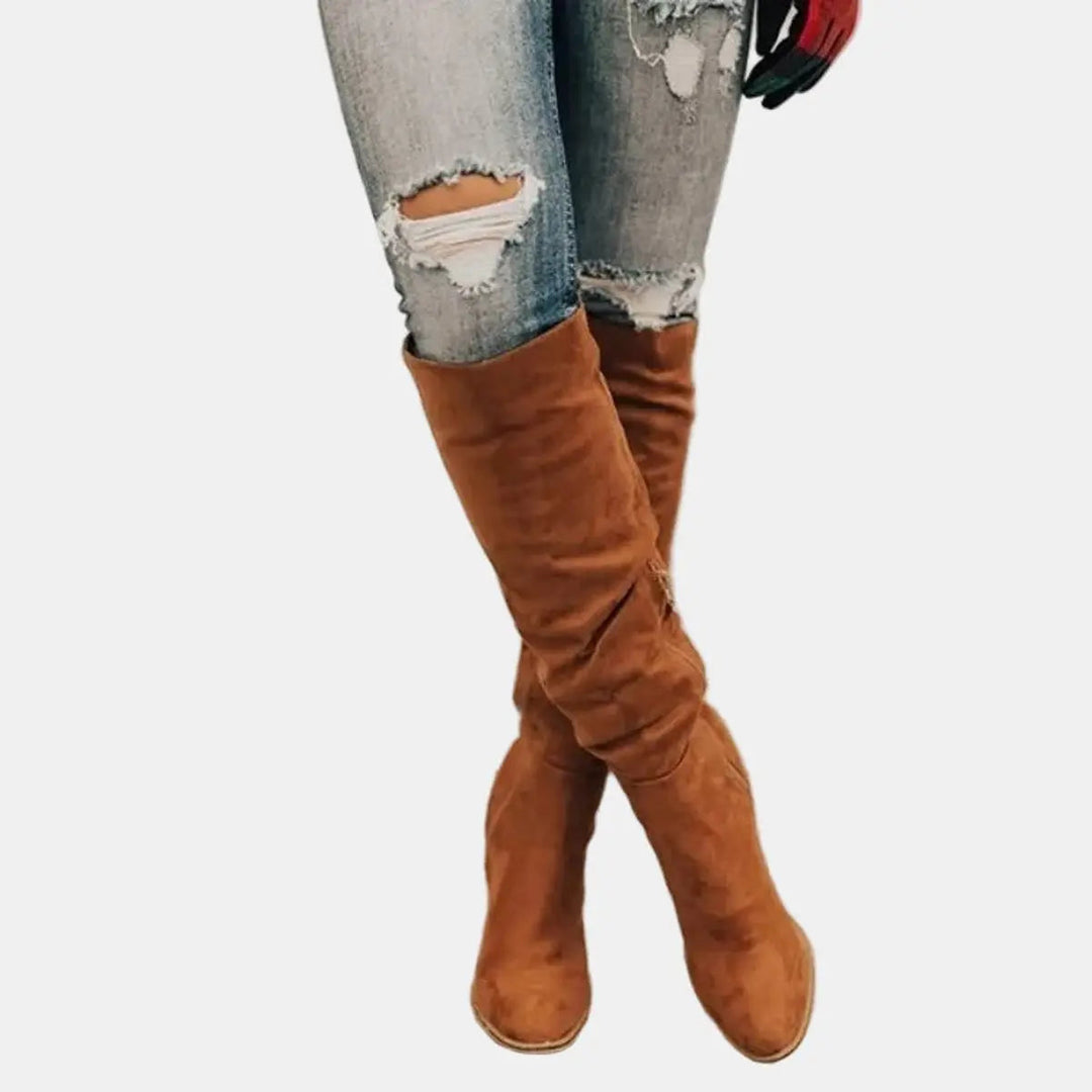 Stylish women's over-the-knee boots with a block heel. Elegant tall fashion boots, perfect for autumn/winter.