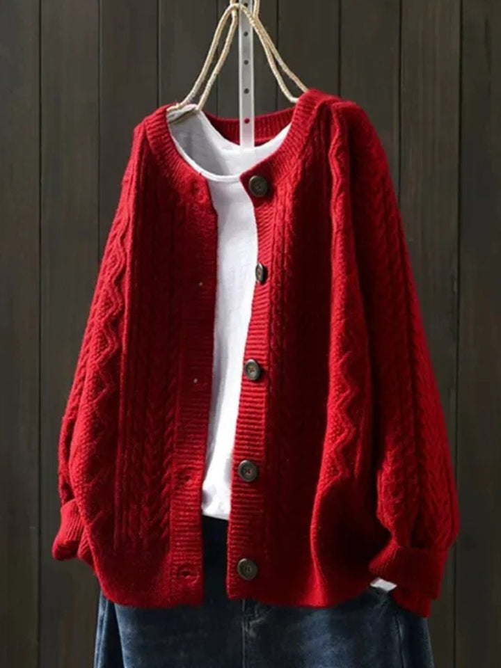 Women's elegant cable-knit button-down cardigan styled as a smart casual top, ideal for timeless fall fashion.