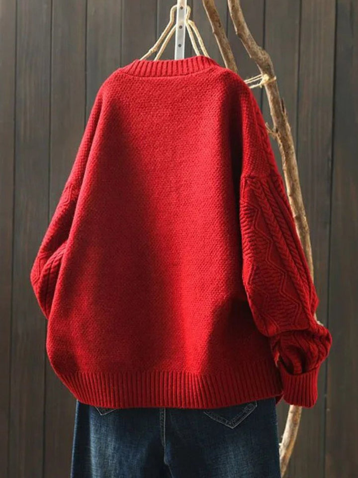 Cozy women's oversized cable-knit cardigan, a luxurious button-down knitwear piece for warm winter layers.