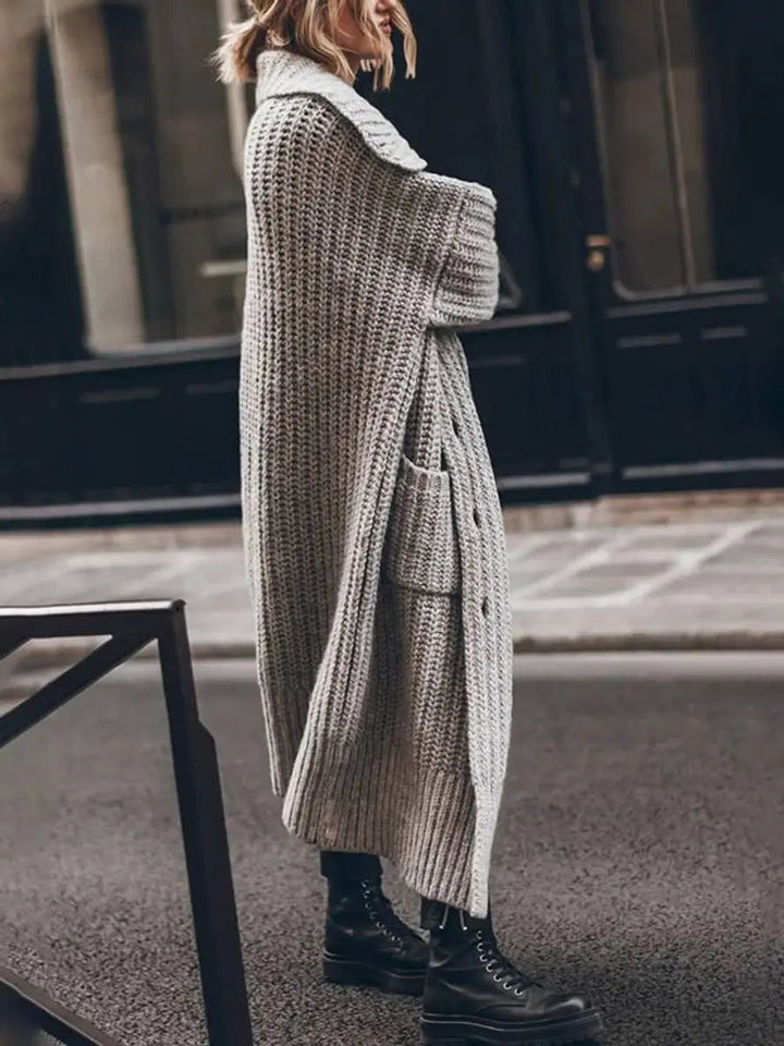 Cozy women's lapel longline cardigan featuring deep pockets for comfort & practical winter style.