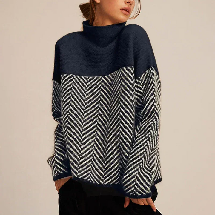 Elegant women's oversized turtleneck sweater with a stylish color-block & chevron design. Comfortable winter statement piece.