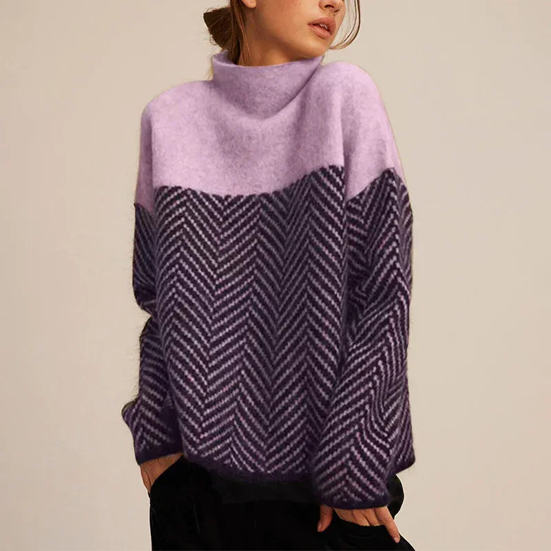 Close-up of a women's cozy oversized color-block turtleneck sweater with a distinctive chevron pattern for fall fashion.