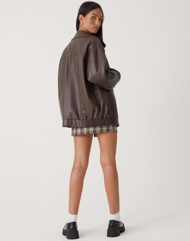 Women's oversized leather jacket in chocolate brown; luxurious, modern, and versatile with stylish front pockets.