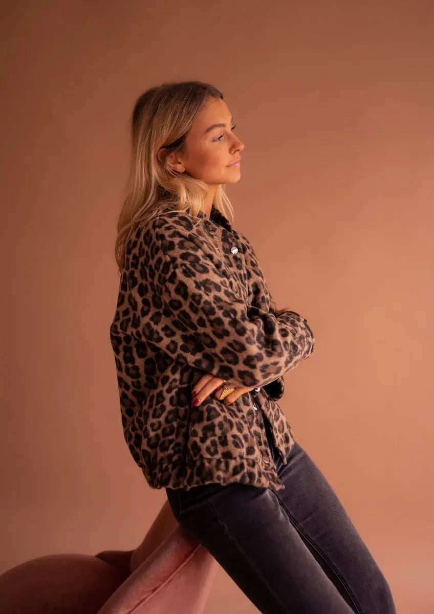 Casual women's oversized quilted jacket with eye-catching leopard print, snap closures, and warmth.