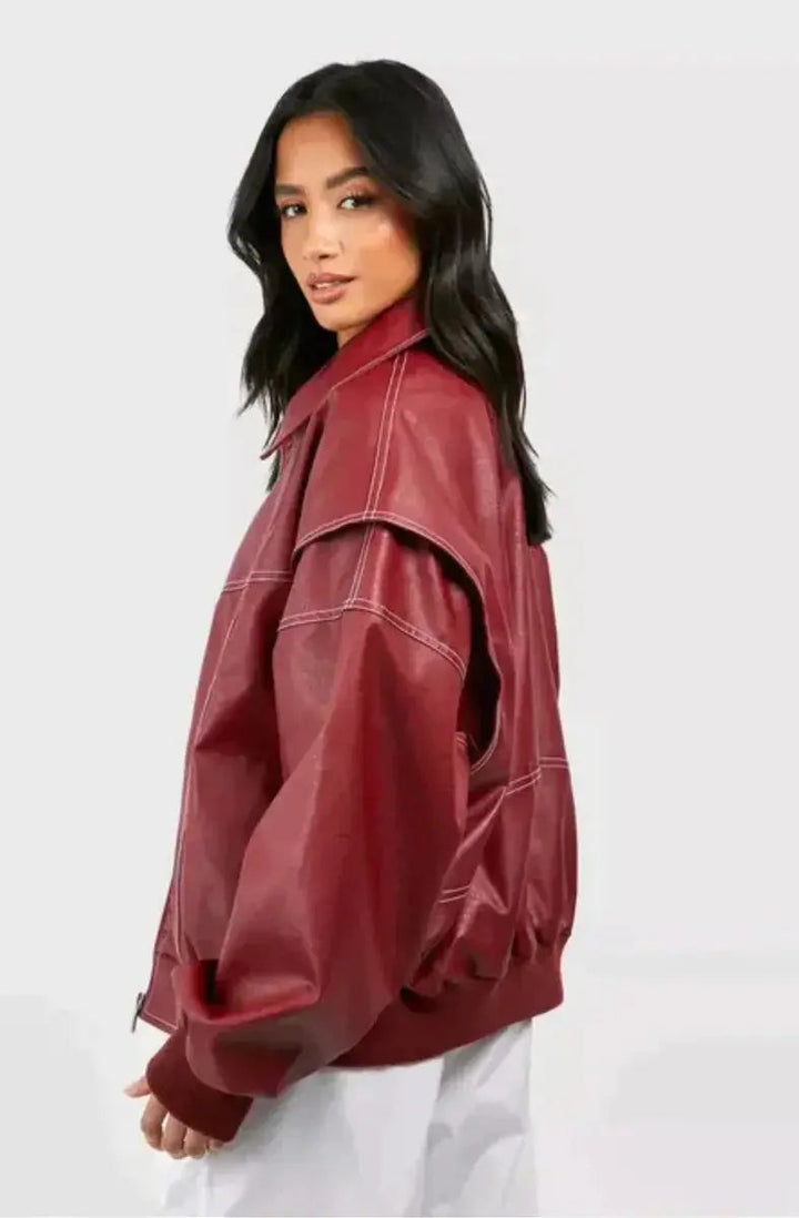Fashionable women's oversized bomber jacket in wine red, showcasing a quilted pattern & sharp contrast stitching.