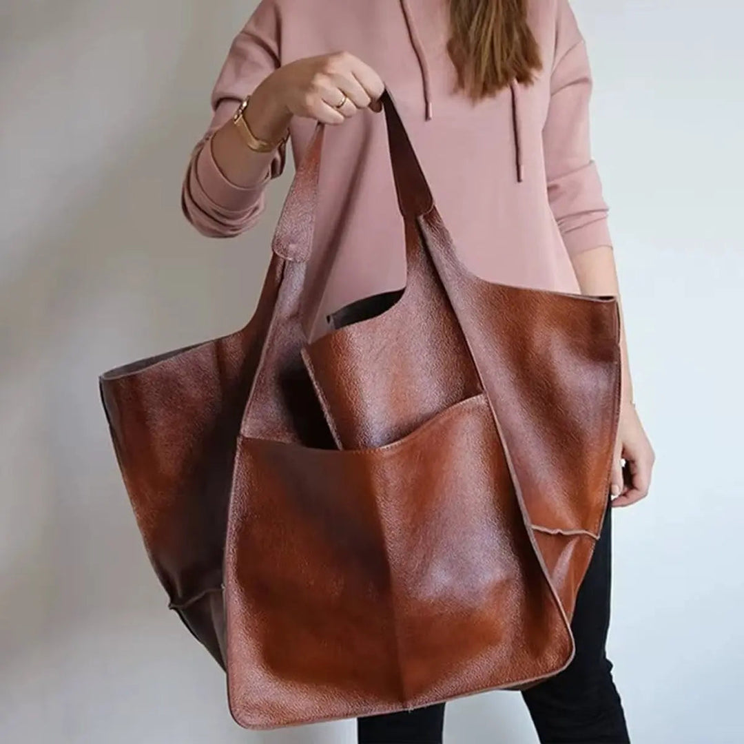 Bottom view of an oversized faux leather work tote, showing sturdy base.