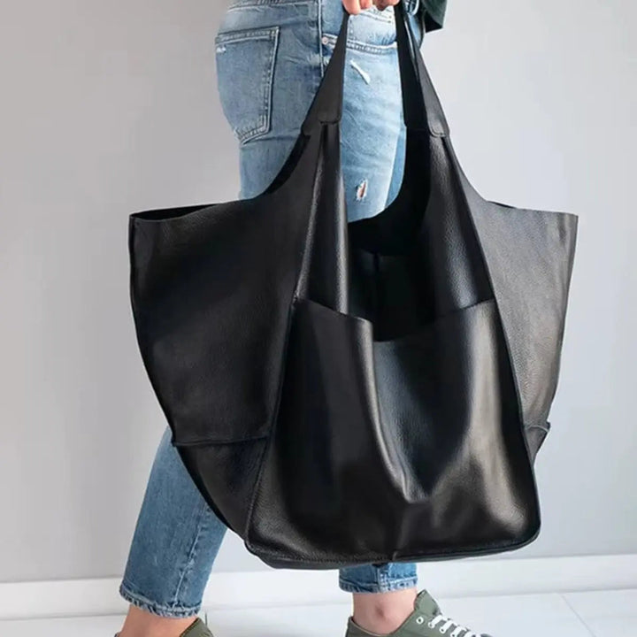 Women's oversized vegan leather fashion tote in black, ideal for office.