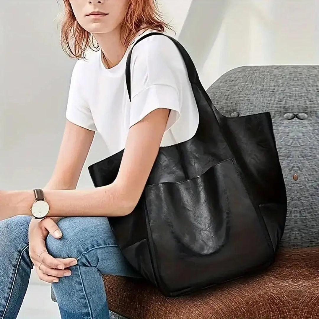 Practical oversized vegan leather tote for women, secure magnetic closure.