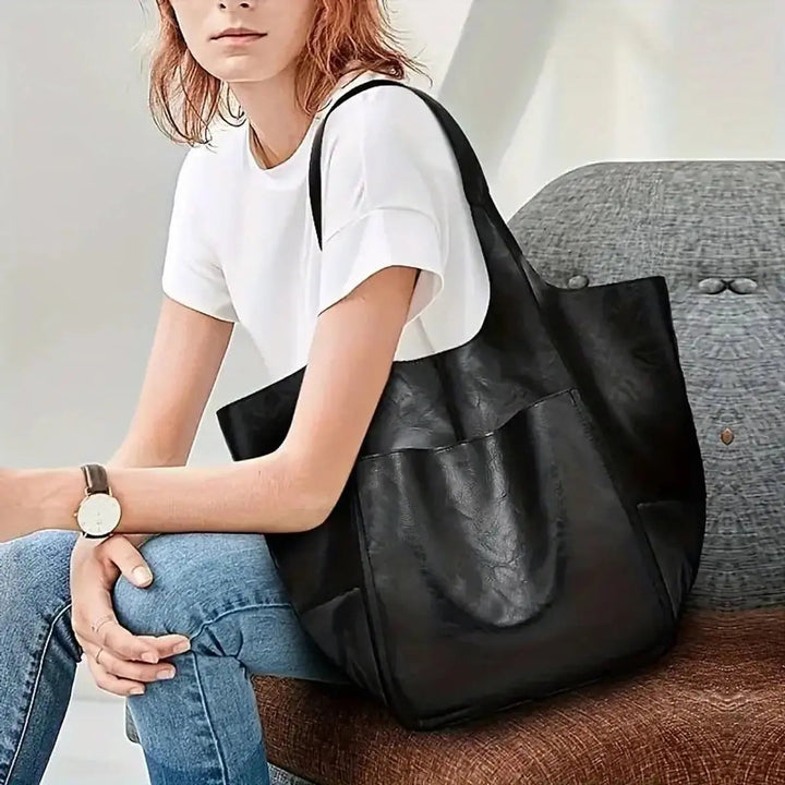 Practical oversized vegan leather tote for women, secure magnetic closure.