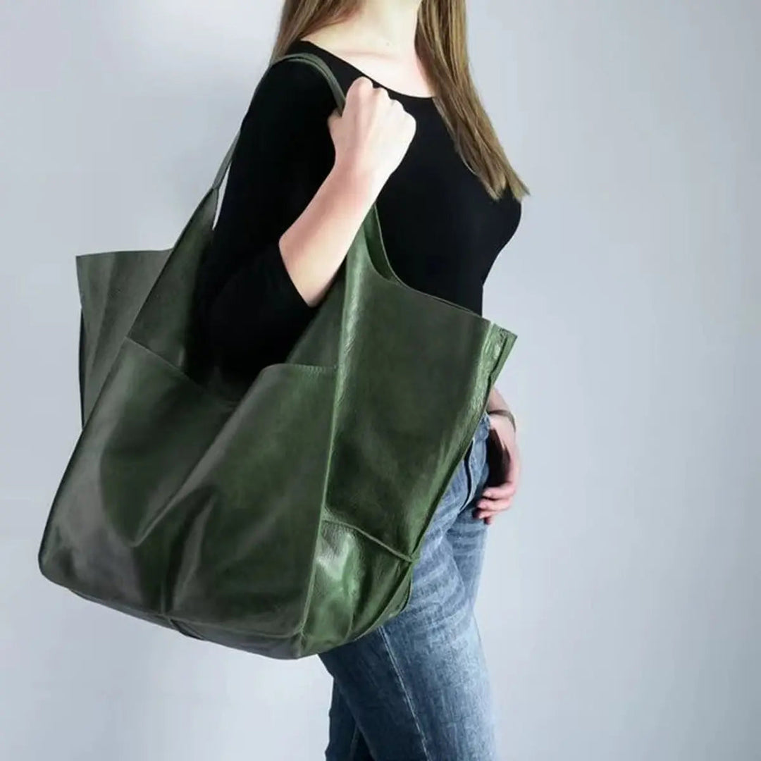 Black oversized vegan leather tote bag with magnetic closure for women.
