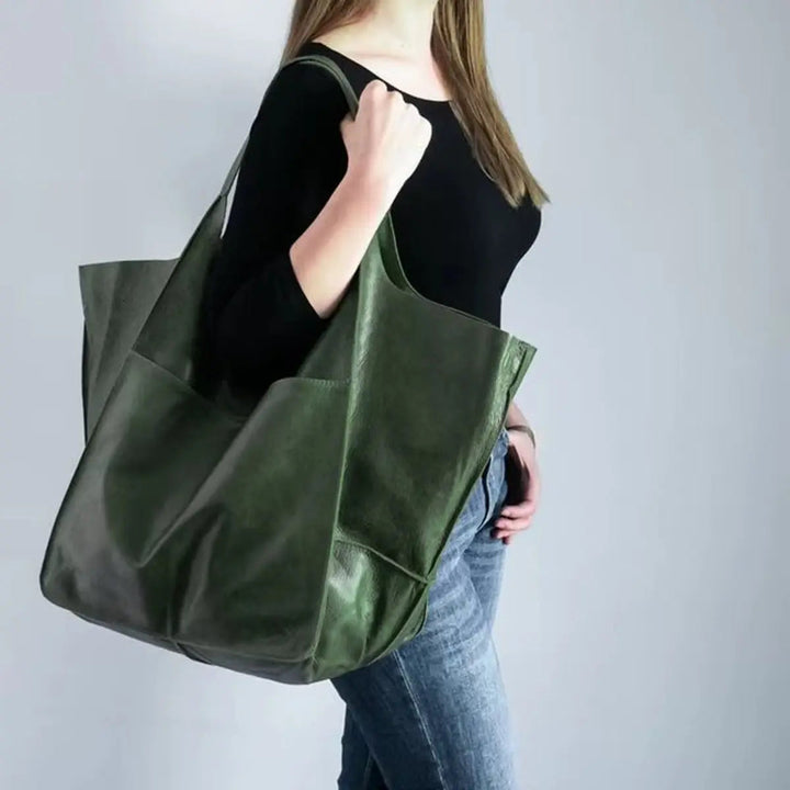 Black oversized vegan leather tote bag with magnetic closure for women.