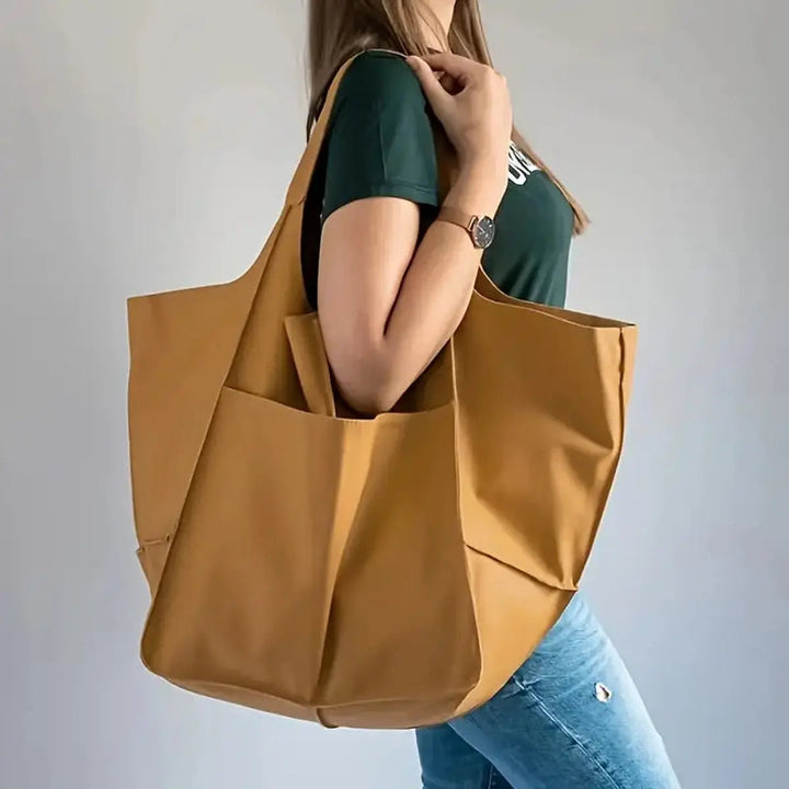 Stylish oversized vegan leather everyday tote bag with secure magnetic closure.