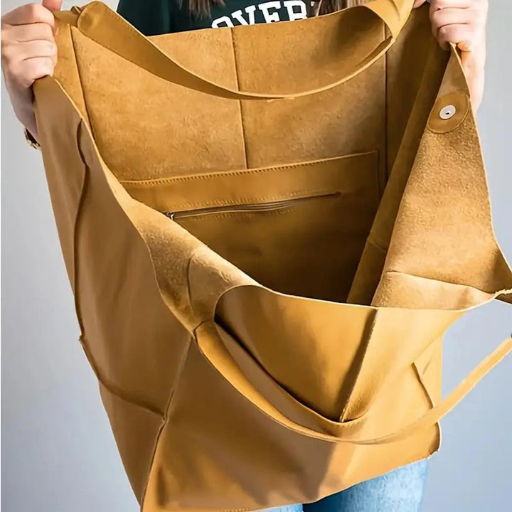 Tan faux leather women's work tote, spacious and elegant with shoulder straps.