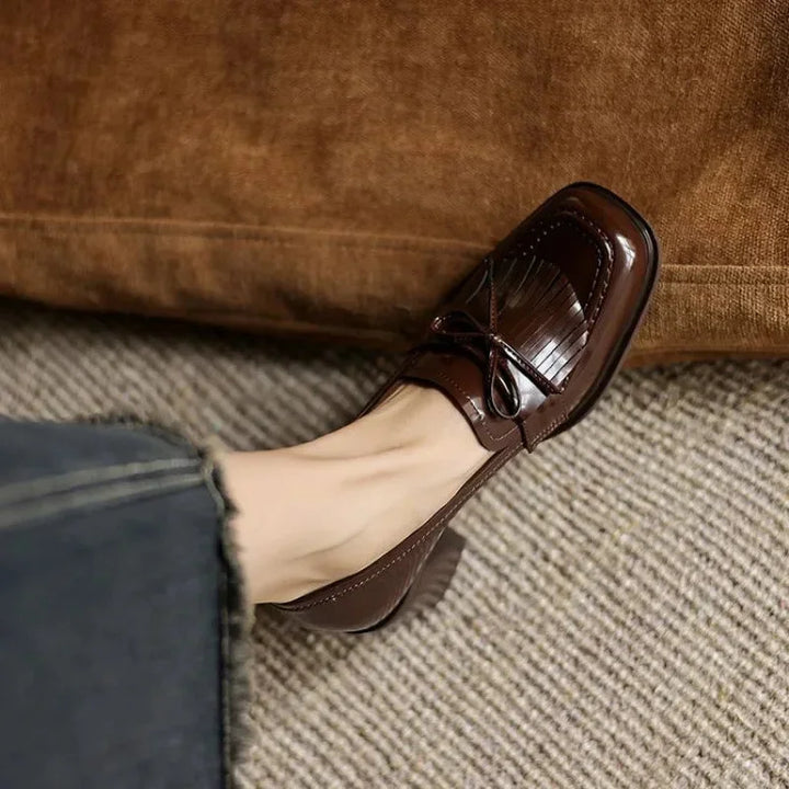 Comfortable block heel loafer pumps for women. Classic round toe & tassel detail, ideal for elegant office footwear.