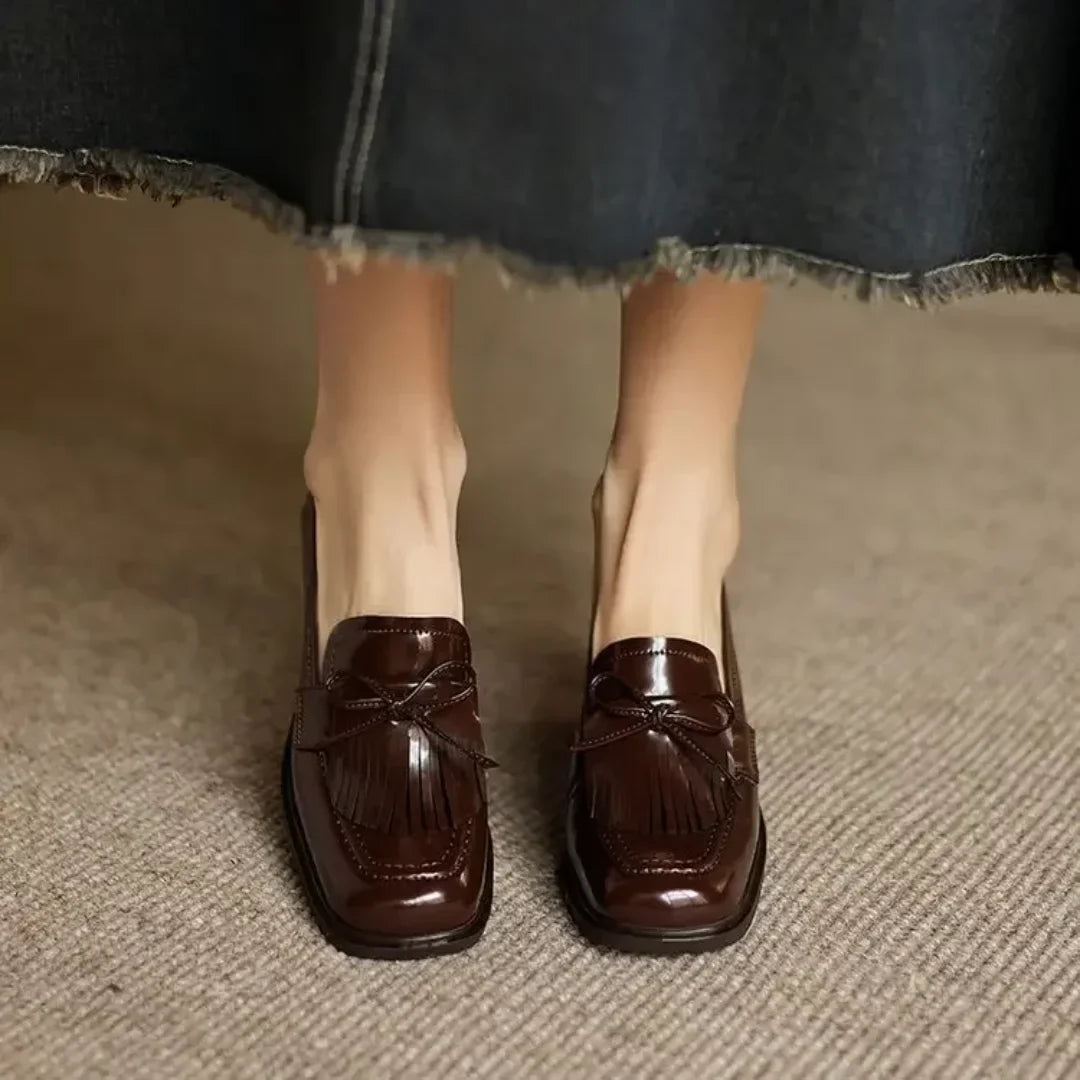 Versatile black women's loafer pumps with tassels & block heel. Elegant, comfortable, classic for office & professional wear.
