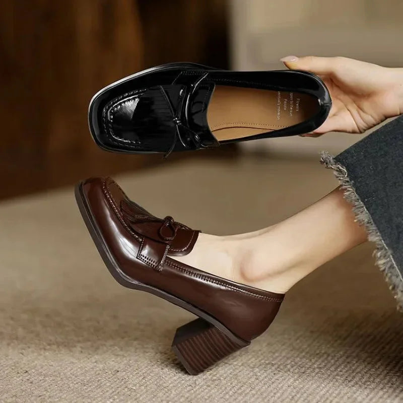 Elegant women's black block heel loafer pumps with tassels. Comfortable classic round toe office & professional footwear.