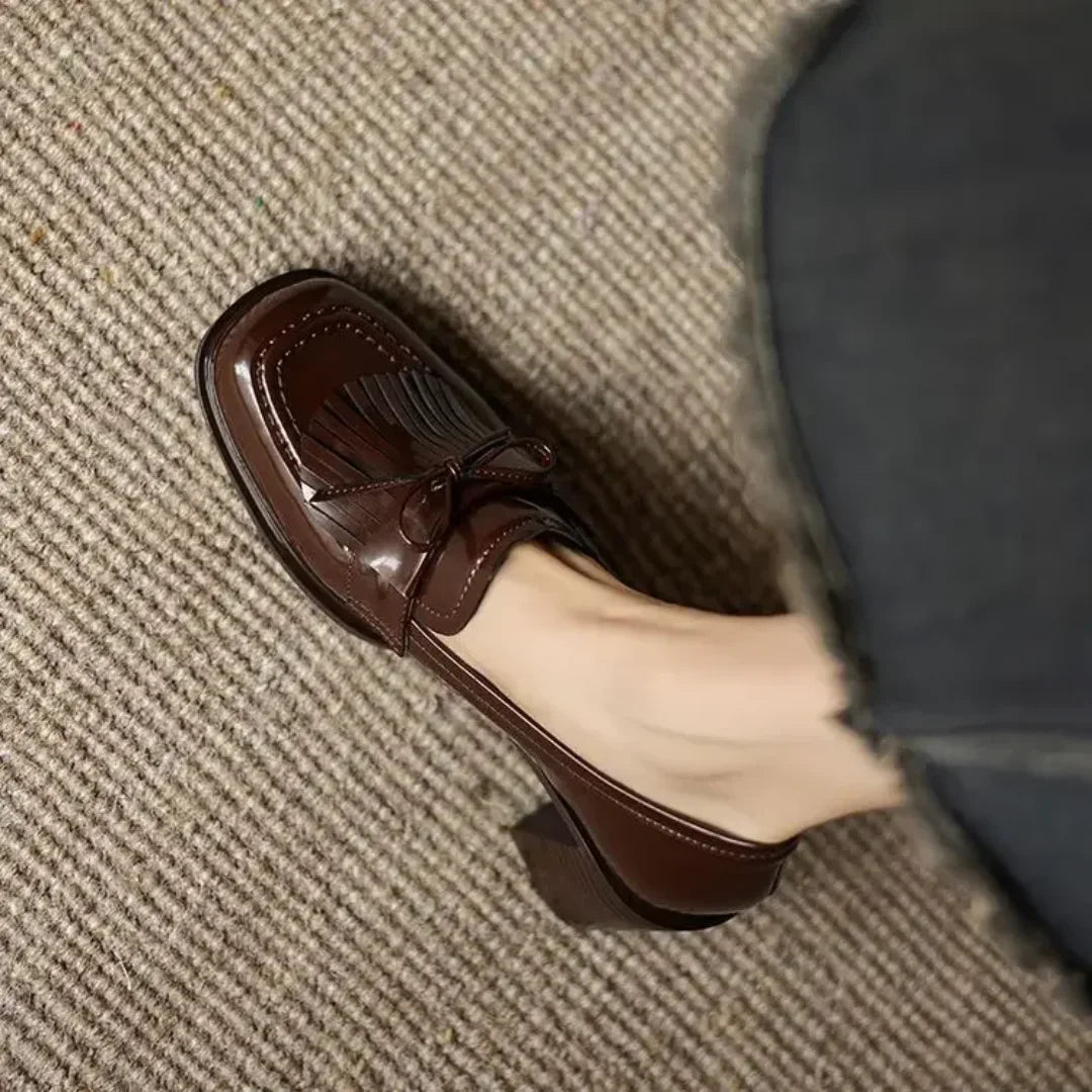 Front view of sophisticated brown women's tassel loafer pumps with a sturdy block heel & stylish round toe.