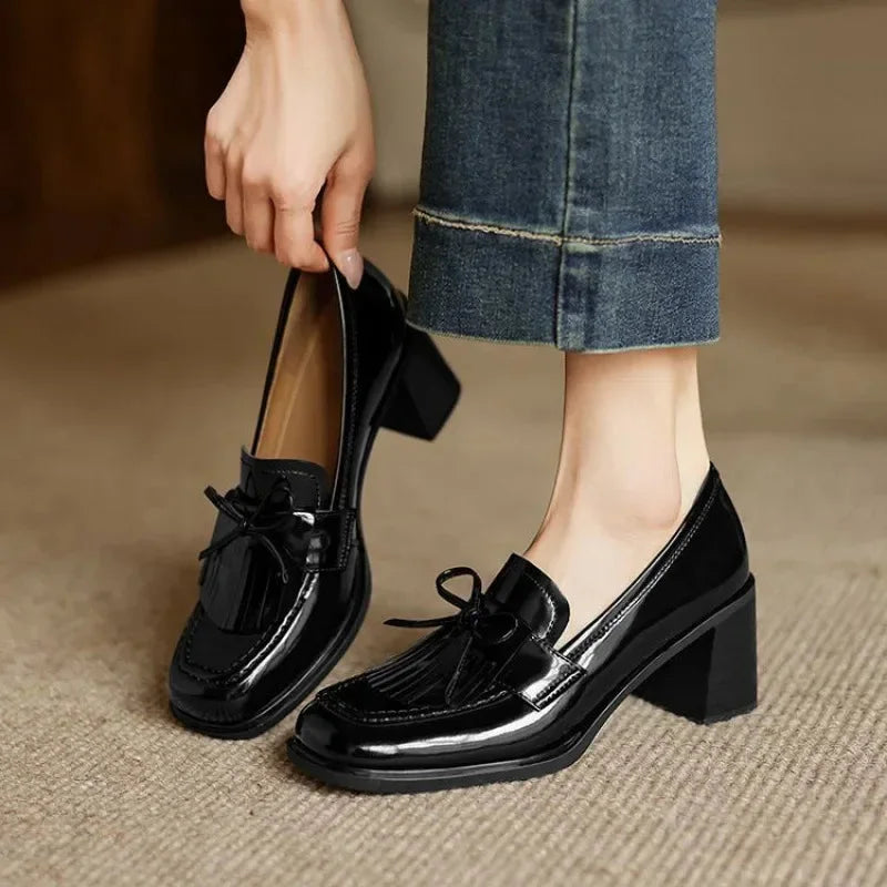 Black women's tassel loafer pumps with block heel. Elegant round toe for office & professional comfortable heels.