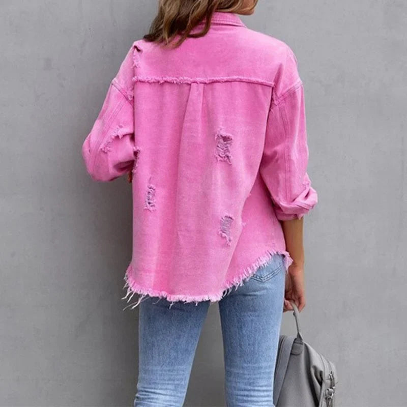 Stylish pink distressed women's denim jacket, featuring a frayed hem and classic button-front design.