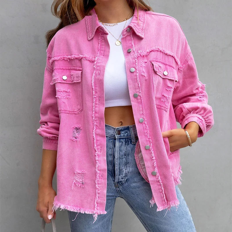 Women's pink distressed denim jacket with frayed hem & button-front closure. Casual vintage style outerwear.