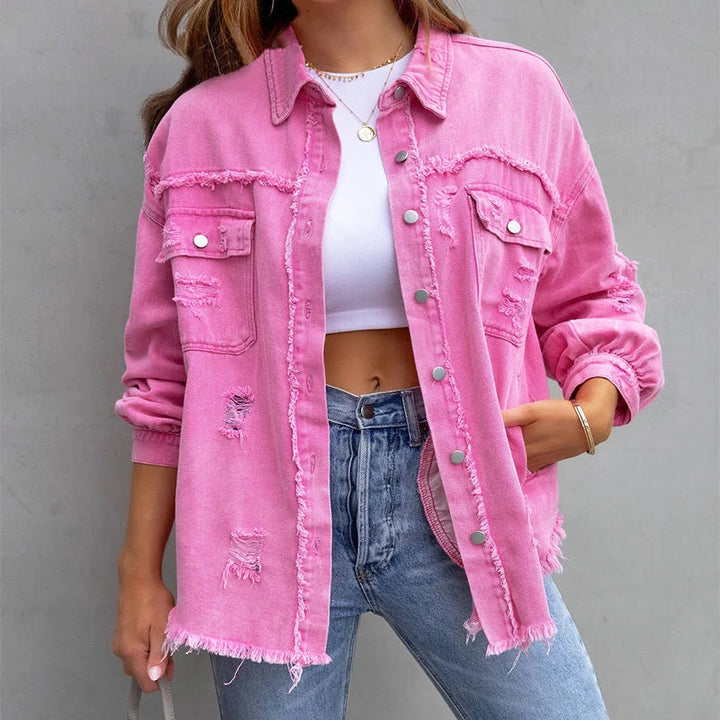 Women's pink distressed denim jacket with frayed hem & button-front closure. Casual vintage style outerwear.