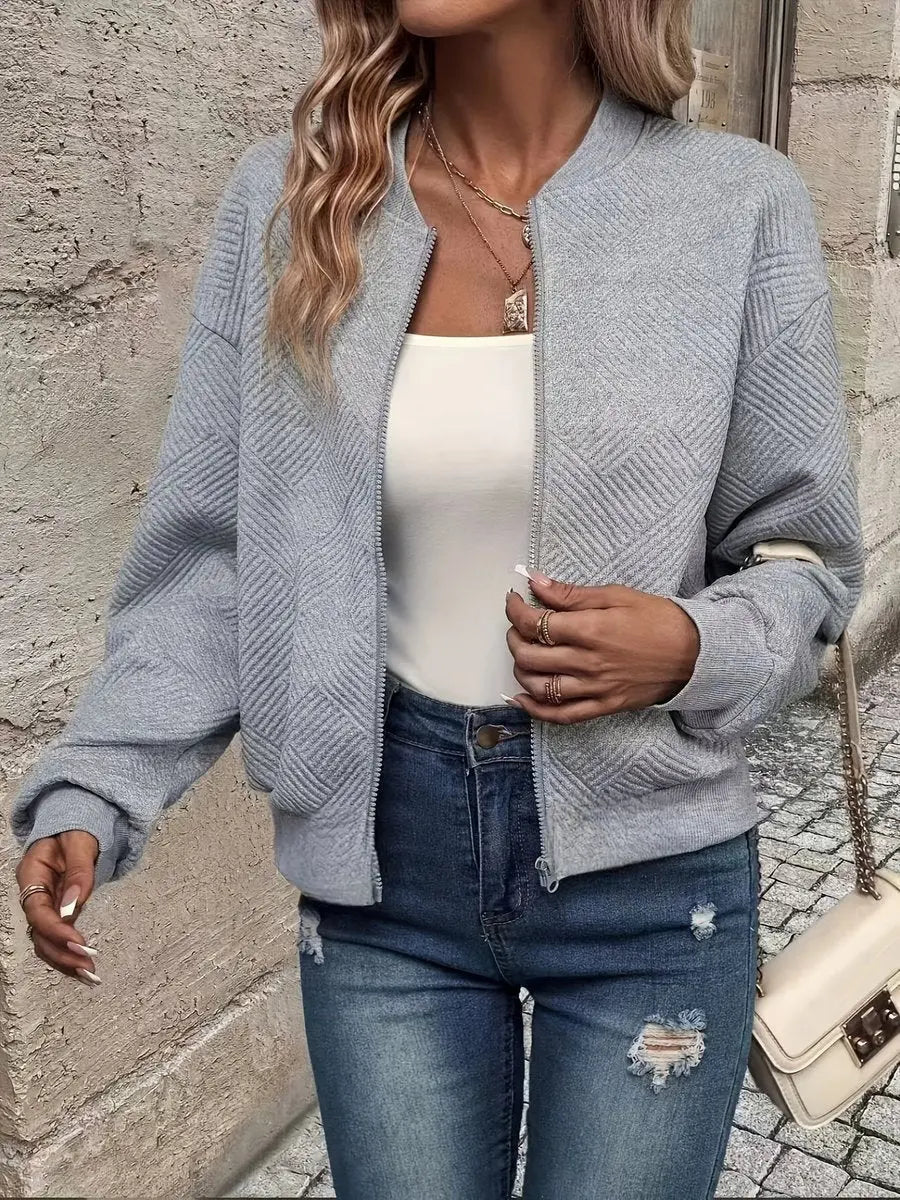Women's cropped quilted bomber jacket, textured finish. A stylish zip-up everyday layering piece for autumn fashion.