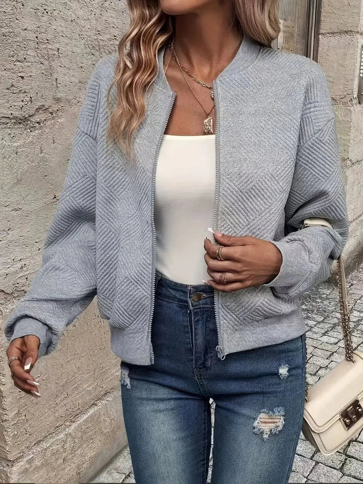 Women's cropped quilted bomber jacket, textured finish. A stylish zip-up everyday layering piece for autumn fashion.