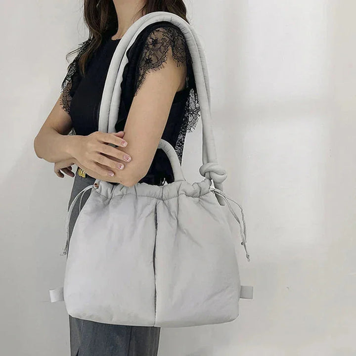 Fashionable women's puffer shoulder bag, quilted design & comfortable knot strap.