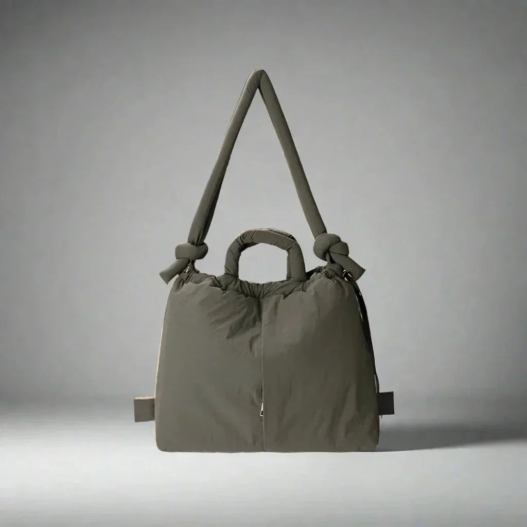 Durable women's quilted puffer tote, great for casual use. Features a stylish knot strap.