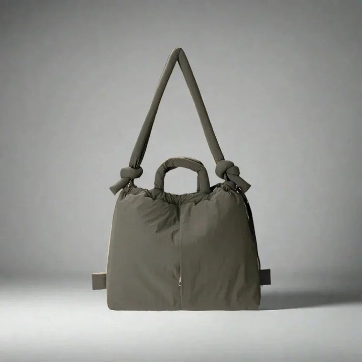 Durable women's quilted puffer tote, great for casual use. Features a stylish knot strap.