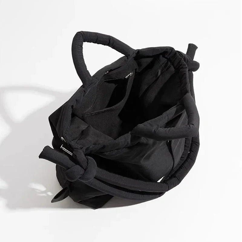 Elegant women's quilted puffer bag, ideal as a shoulder bag or stylish carryall. Knot strap.