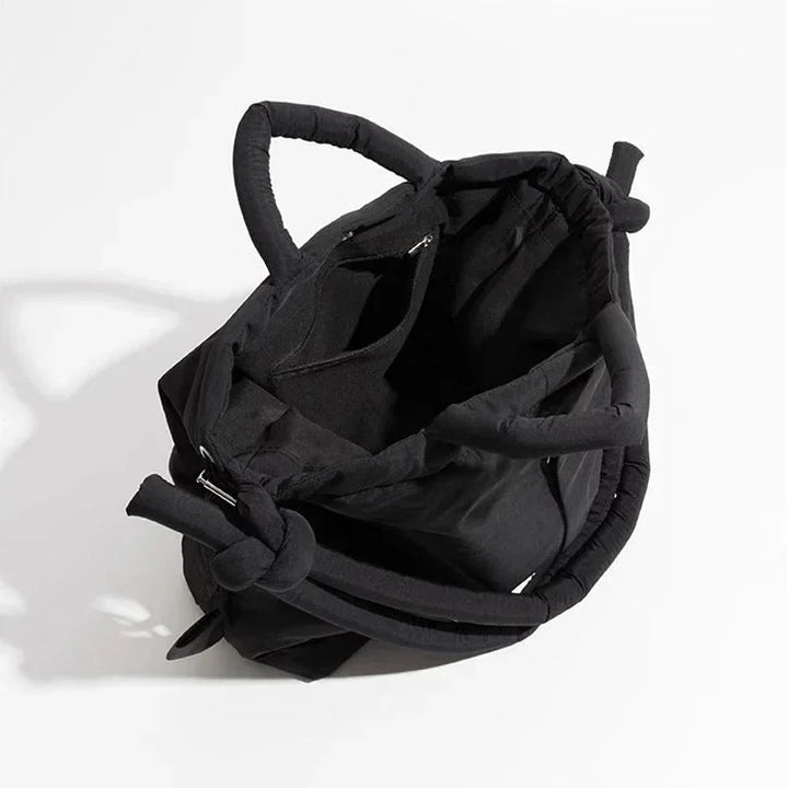 Elegant women's quilted puffer bag, ideal as a shoulder bag or stylish carryall. Knot strap.