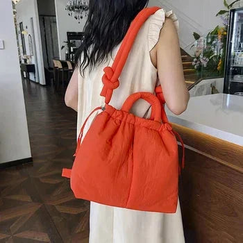 Casual chic women's tote bag. Soft quilted puffer material & unique knot strap detail.