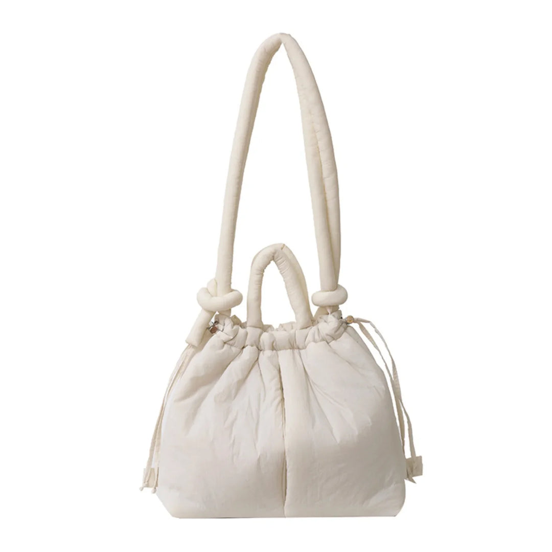 Trend-setting women's puffer bag. Quilted design and an eye-catching knot shoulder strap.