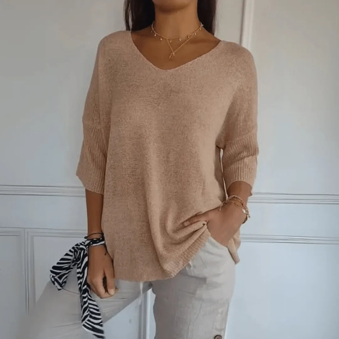 Stylish women's V-neck top with 3/4 sleeves & relaxed fit, ideal for spring fashion and comfort.