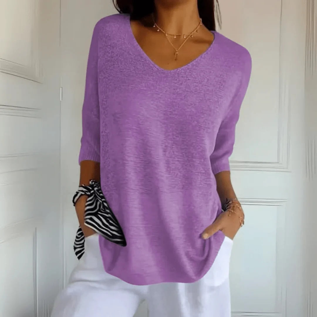 Relaxed V-neck women's top, 3/4 sleeves. Comfortable & versatile for casual spring/summer fashion.