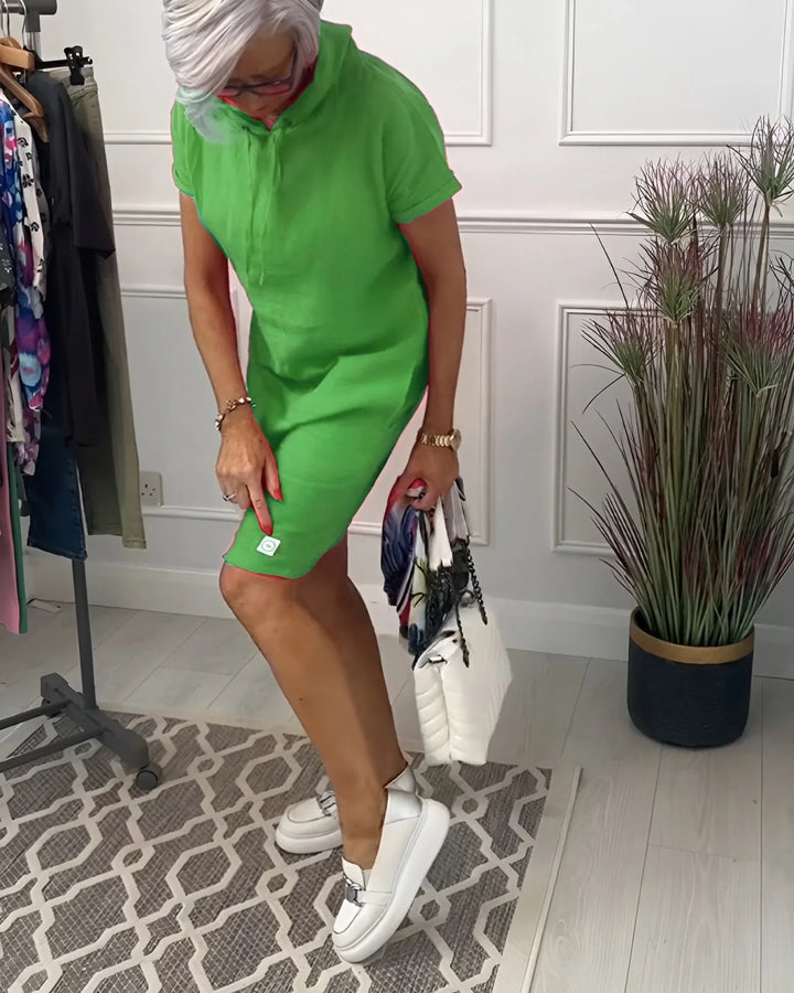 Side view of a women's short sleeve hoodie mini dress with pockets, highlighting its relaxed fit.