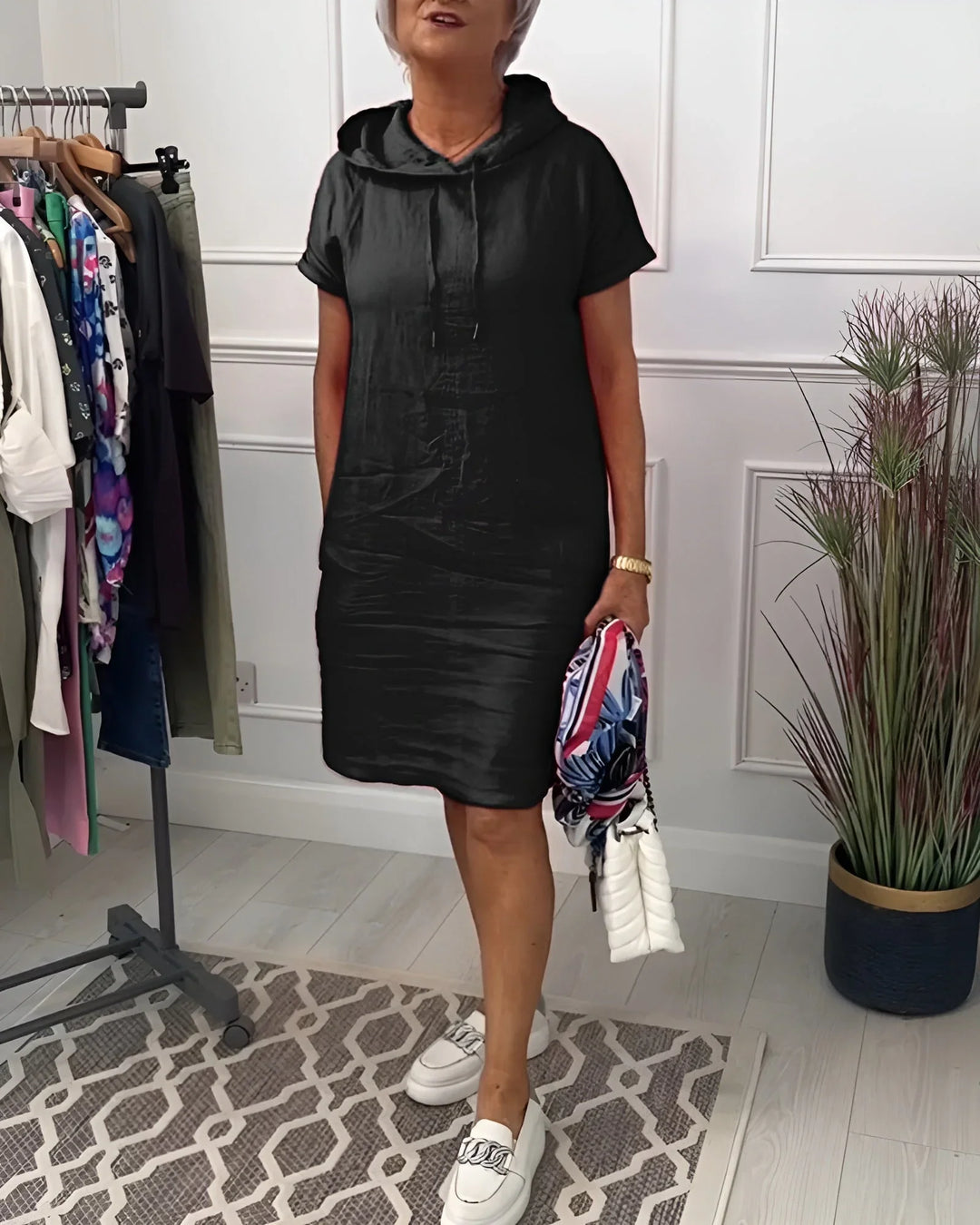 Loose fit women's short sleeve hoodie mini dress, with practical pockets for a relaxed summer outfit.