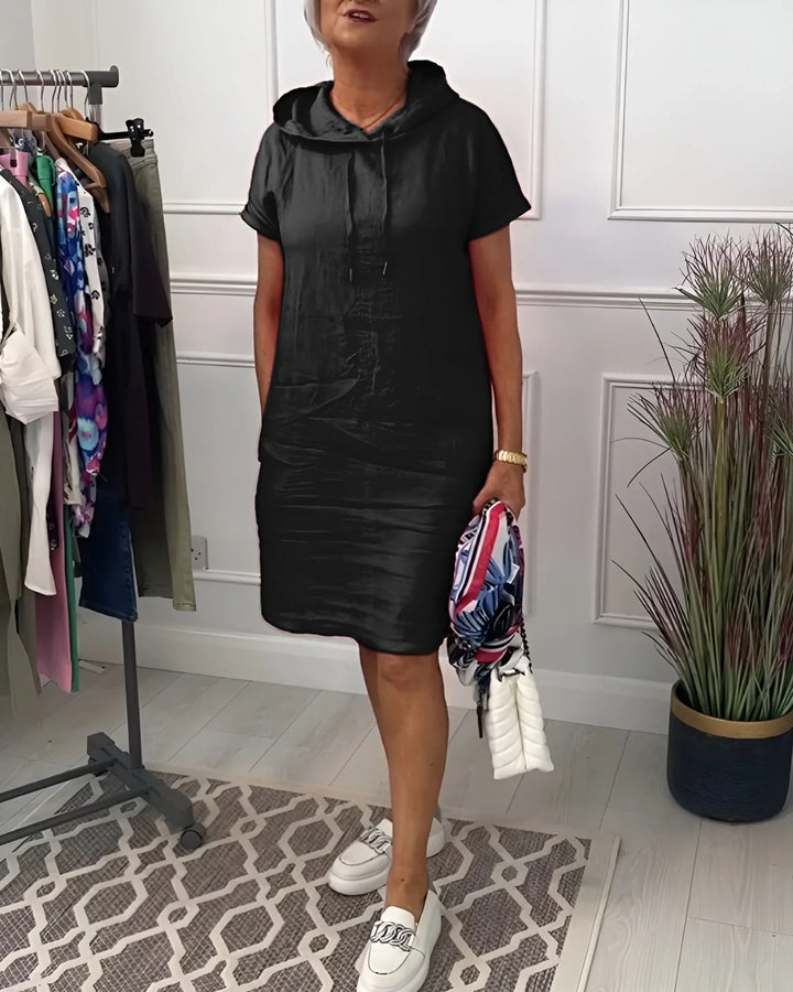 Loose fit women's short sleeve hoodie mini dress, with practical pockets for a relaxed summer outfit.
