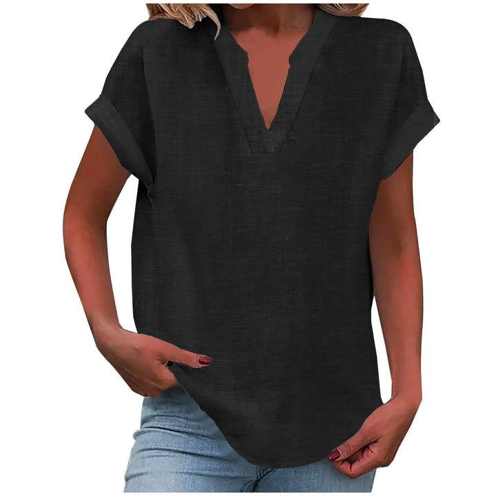 Detailed image of a women's V-neck blouse, showing cuffed sleeves and relaxed, flowy fabric.