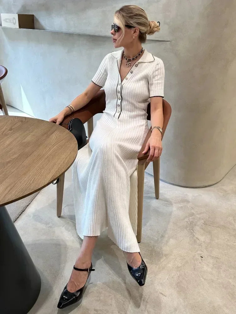 "Women's ribbed knit maxi dress with collared V-neck, button details, and flowing silhouette in versatile colors."