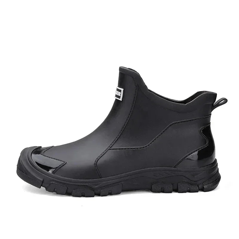 Black women's waterproof ankle rain boots with a durable, slip-resistant lug sole for extreme wet conditions.