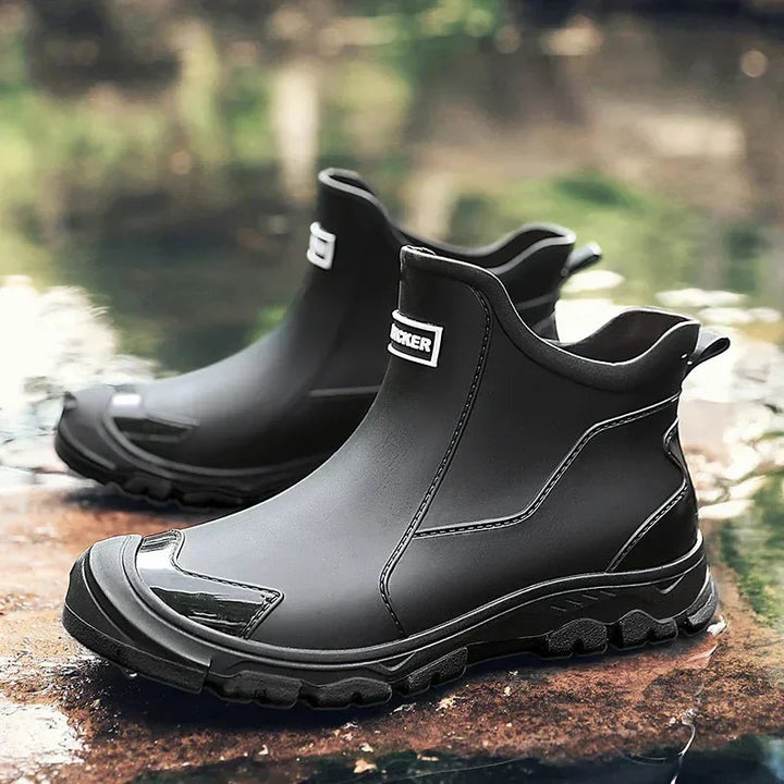 Women's rugged waterproof ankle rain boots with a slip-resistant lug sole, ideal for wet weather.