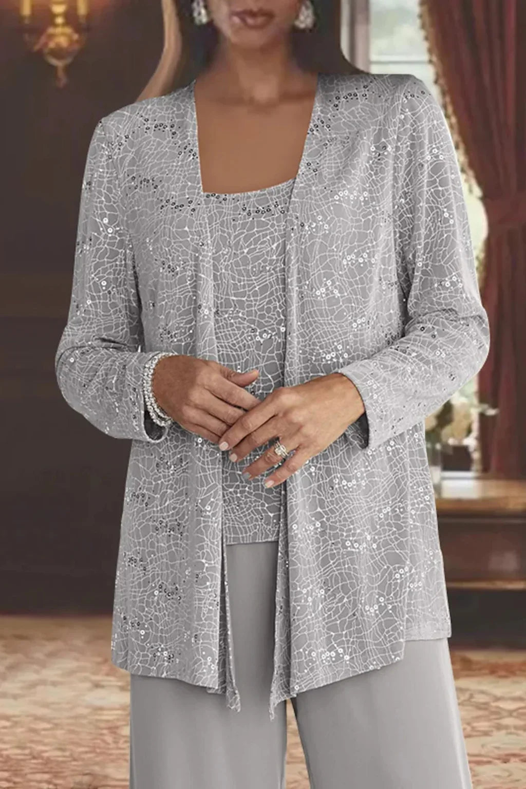 Elegant sequin jacket for women, paired with wide leg pants; a stunning party outfit.